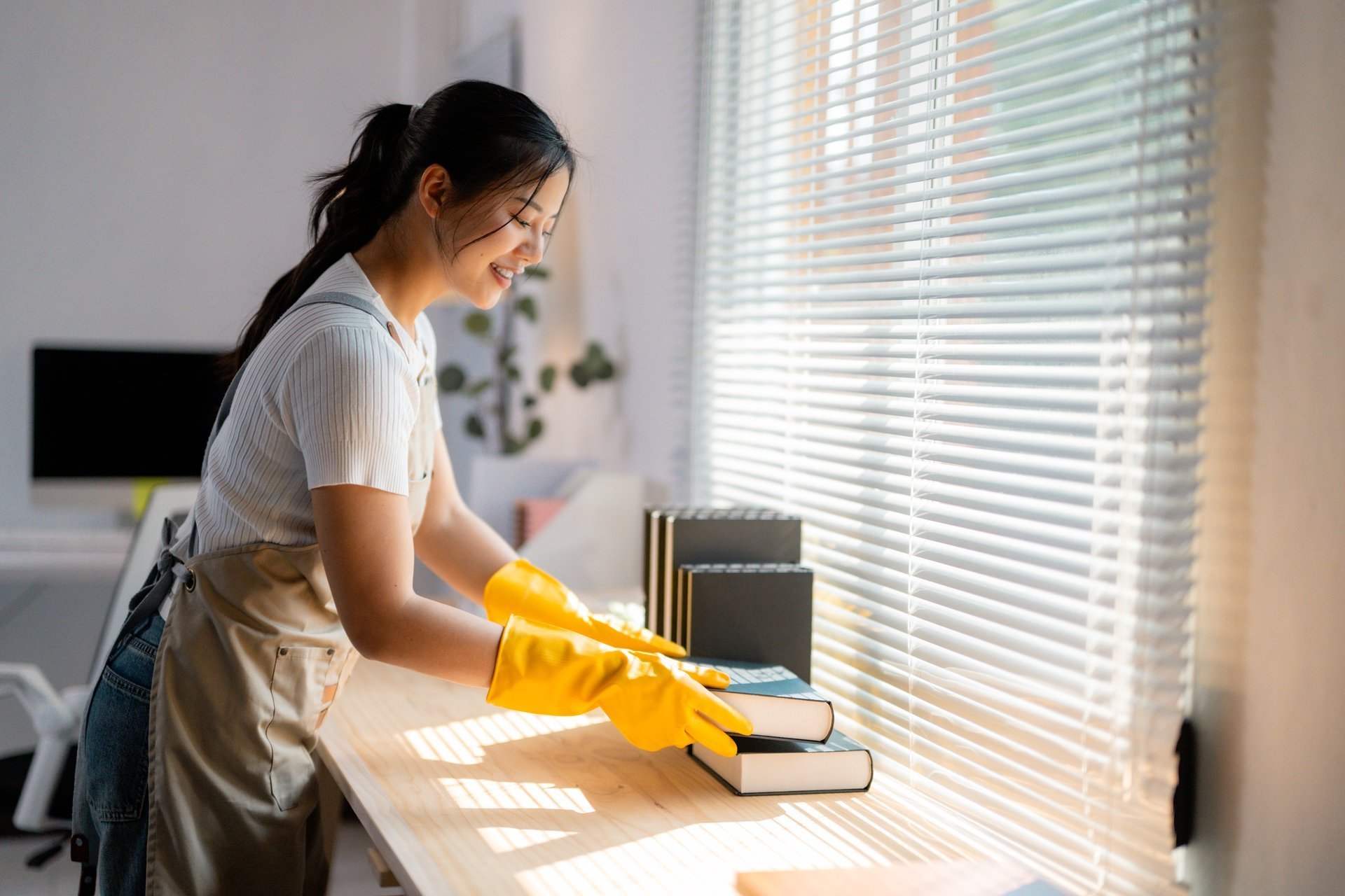 Professional housekeeper cleaning with yellow gloves